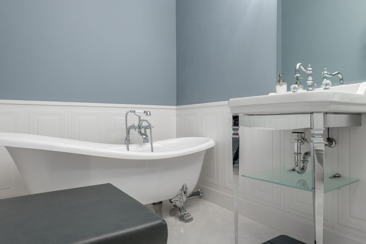 services-09 Interior of stylish bathroom with empty white bathtub and sink in luxury modern flat